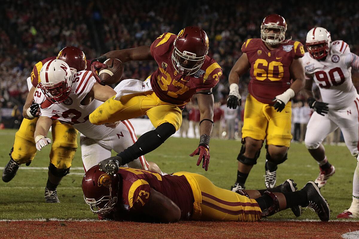 Trojans running back Javorius Allen leaps over teammate Zach Banner (73) for a touchdown against the Cornhuskers in the second quarter.