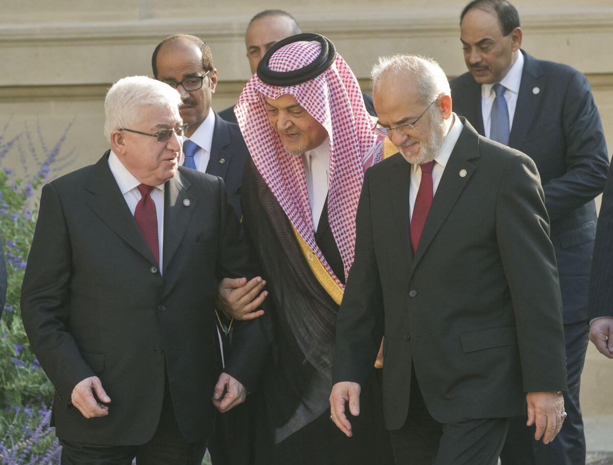 Iraqi President Fouad Massoum, left, talks with Saudi Foreign Minister Prince Saud al Faisal, center, and Iraqi Foreign Minister Ibrahim al Jaafari at a diplomatic meeting in Paris on Monday.