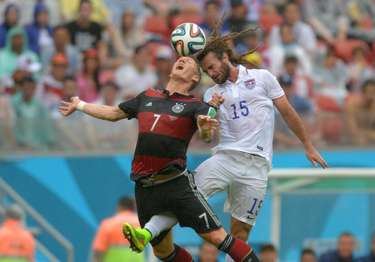 Bastian Schweinsteiger of Germany and Kyle Beckerman of the U.S. vie for a ball during a Group G match Thursday. Germany defeated the U.S., 1-0, but both team advanced to the round of 16.