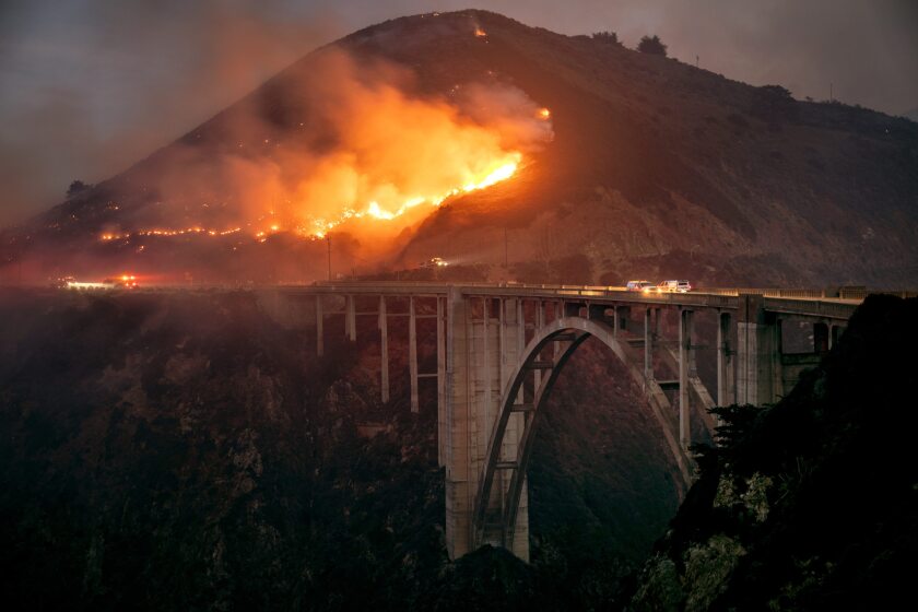 The Colorado Fire burns down toward the Bixby Bridge in Big Sur, Calif., early Saturday morning, Jan. 22, 2022. (Karl Mondon/Bay Area News Group via AP)