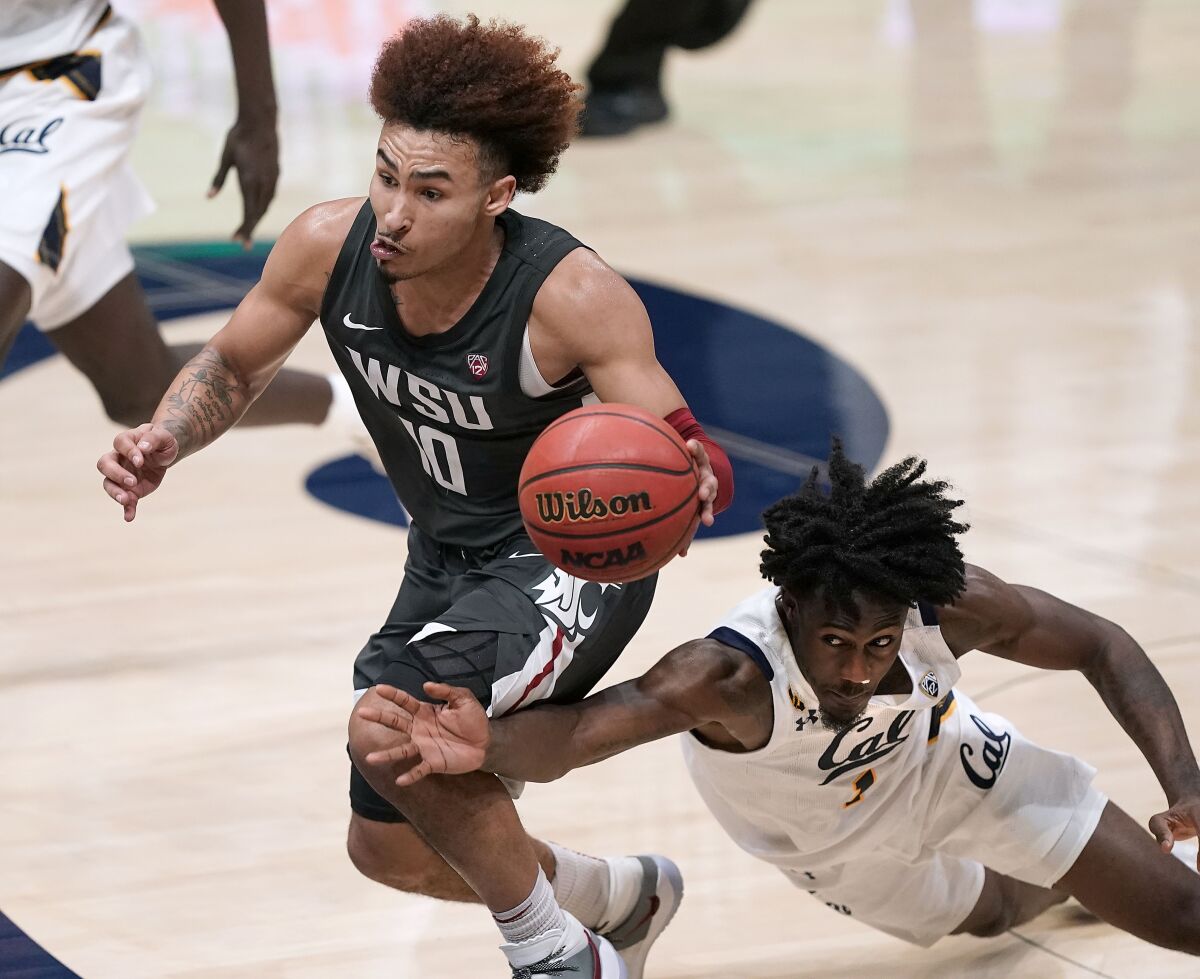 Washington State guard Isaac Bonton (10) is fouled by California guard Joel Brown (1) during the second half of an NCAA college basketball game Thursday, Jan. 7, 2021, in Berkeley, Calif. (AP Photo/Tony Avelar)