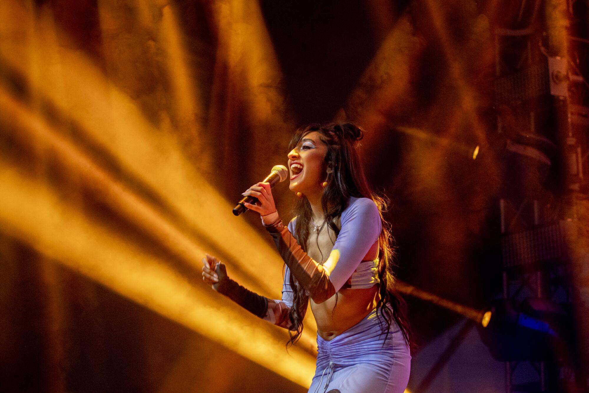 A woman sings onstage