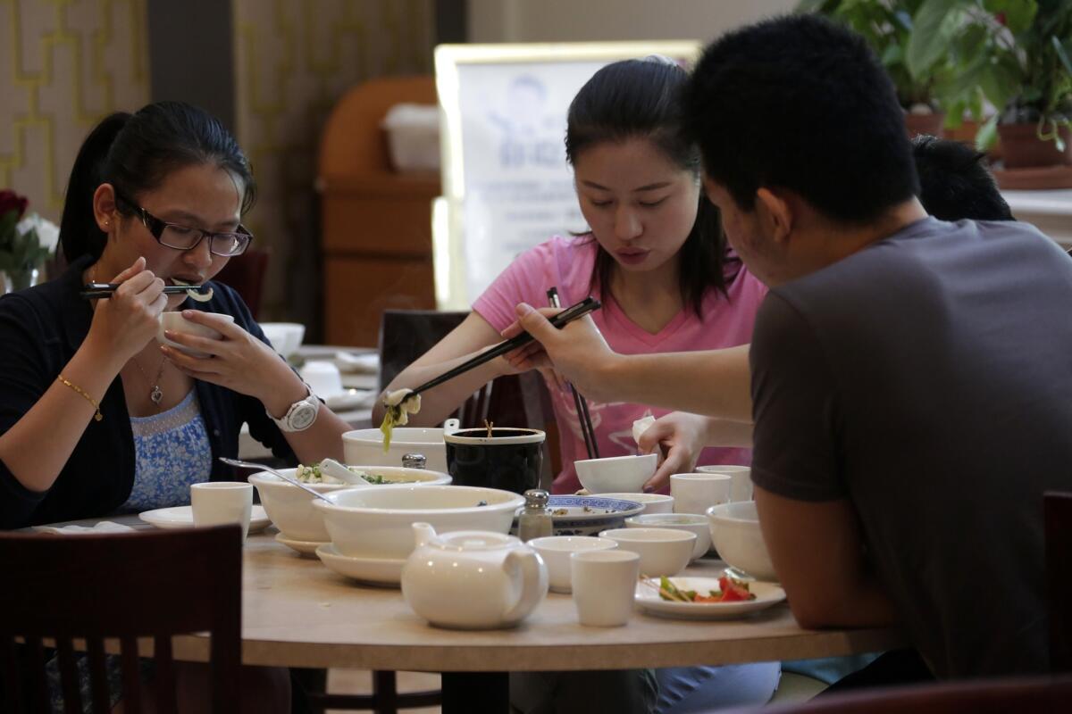 The cuisine at Awu is from the Henan province in eastern China. Here, diners share braised noodle with mutton soup.