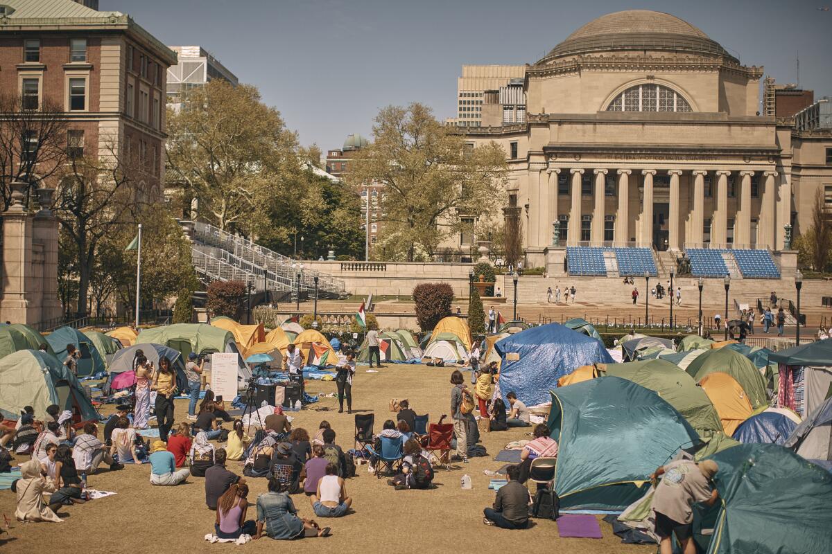 People listen to a speaker at a pro-Palestinian encampment at Columbia University.