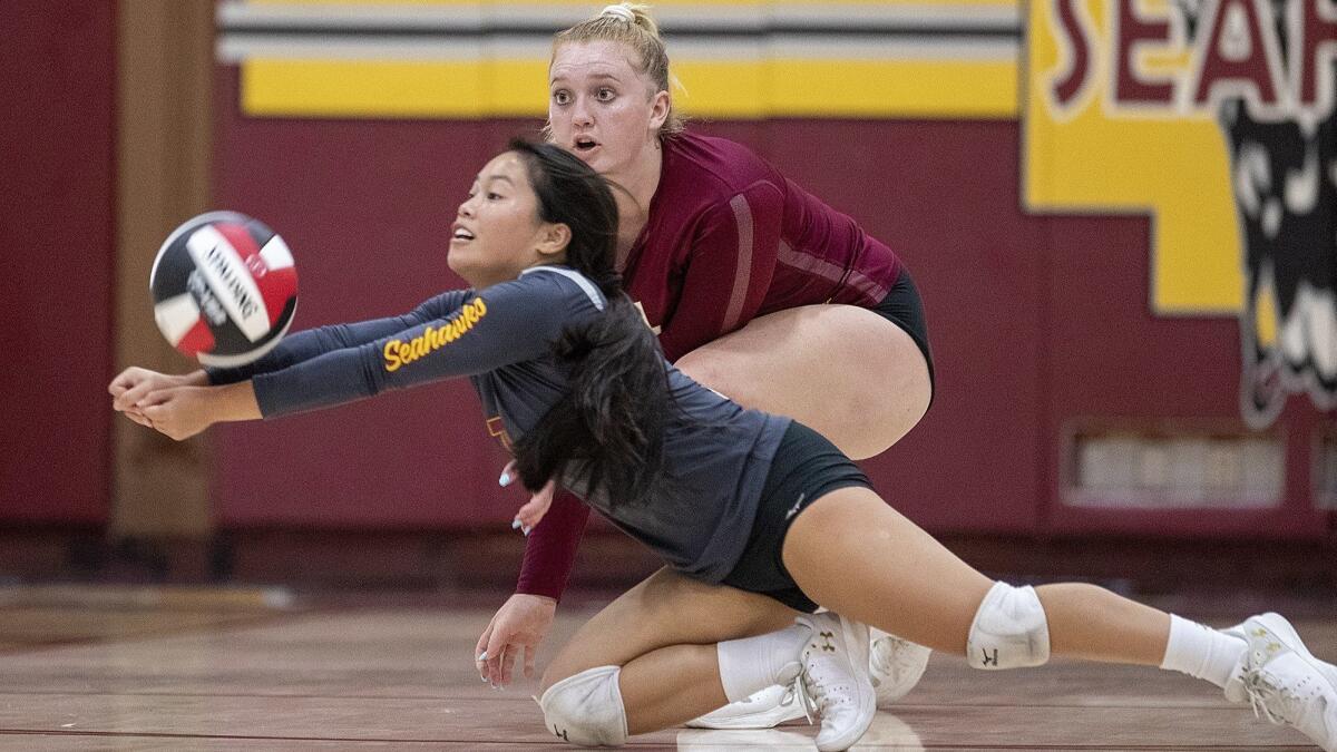 Ocean View High libero Kelli Greiner digs the ball in front of Katelyn Taylor during a Golden West League match against Garden Grove on Oct. 2.