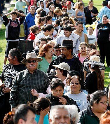 Thousands line up hours before a food and clothing giveaway at Montebello Park.