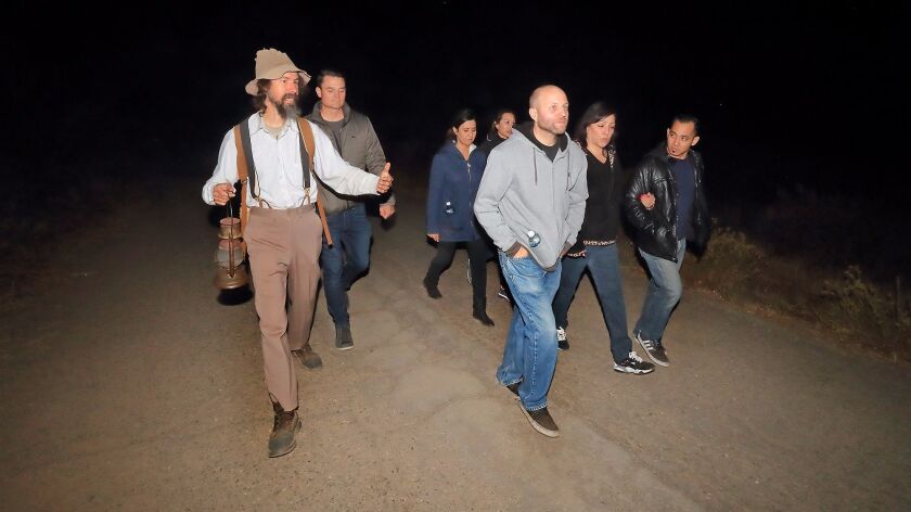 Joel Robinson, far left, leads a walking tour into Black Star Canyon in Silverado as part of Haunted OC.