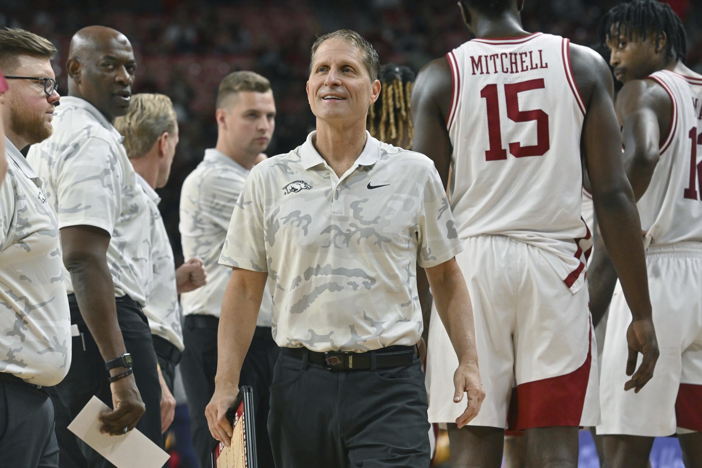 Arkansas coach Eric Musselman smiles on the sidelines during a game against UNC Greensboro.