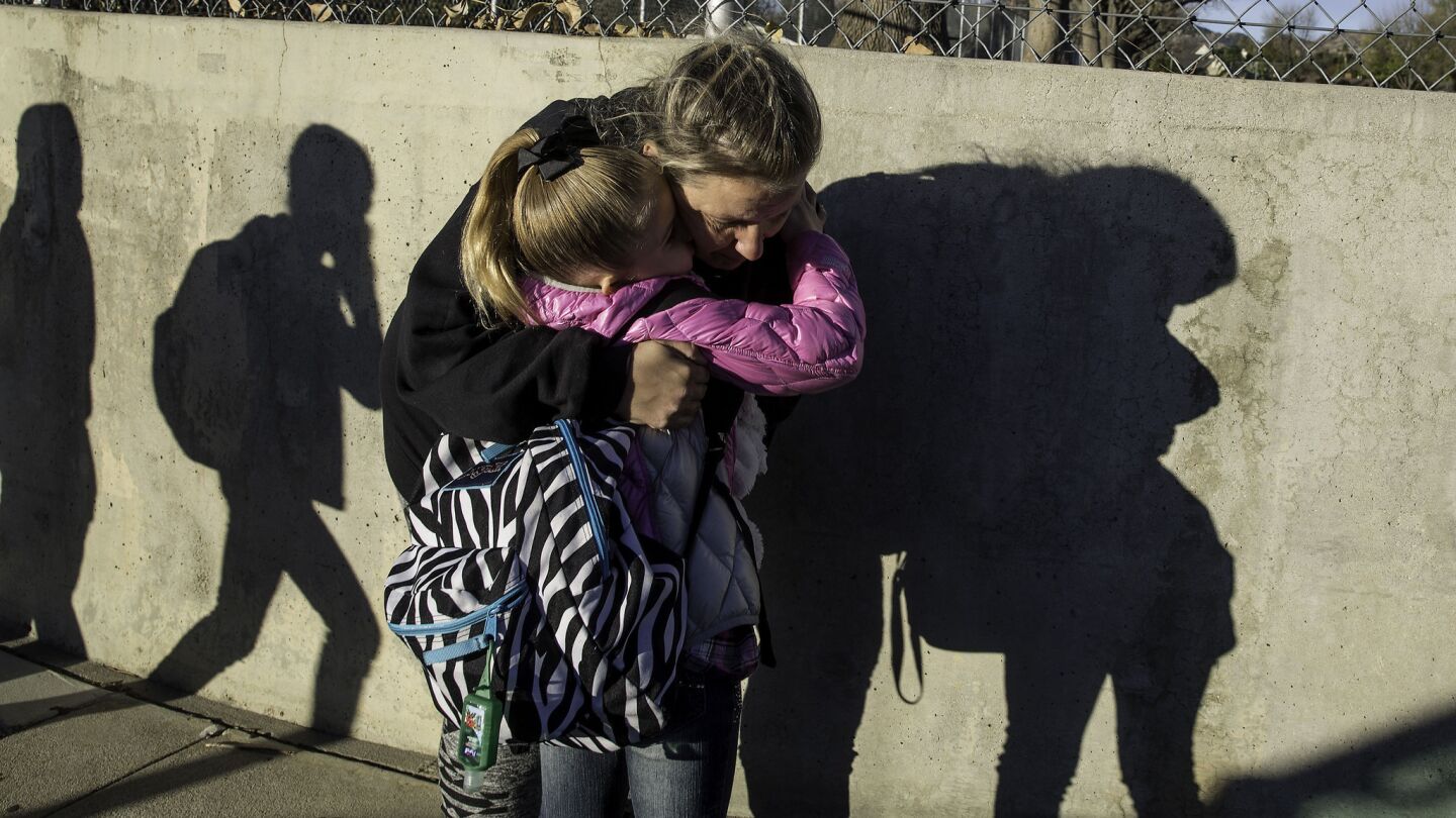 Tiffany Hooper drops off her 8-year-old daughter Leah Hooper with a hug at Germain Street Elementary School in Chatsworth.