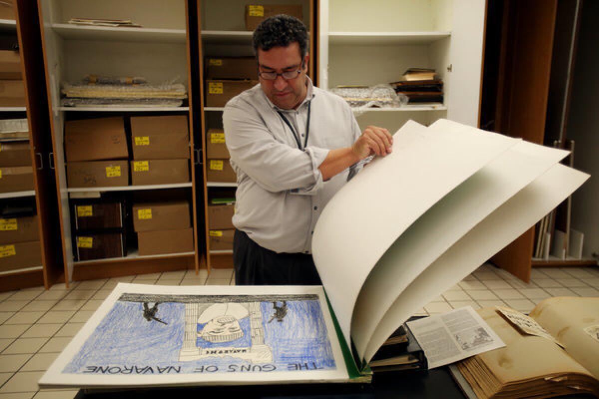 Daniel Hernandez, Chicano Resource Center librarian, looks through some of the archival material from the Anthony Quinn Library in East Los Angeles.