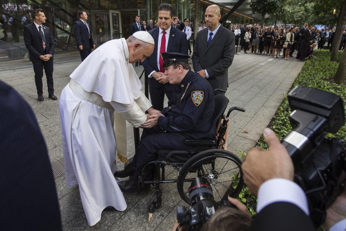 Pope Francis shakes the hand of a New York Police Department officer while visiting the 9/11 Memorial plaza in New York. (AFP/Getty Images)