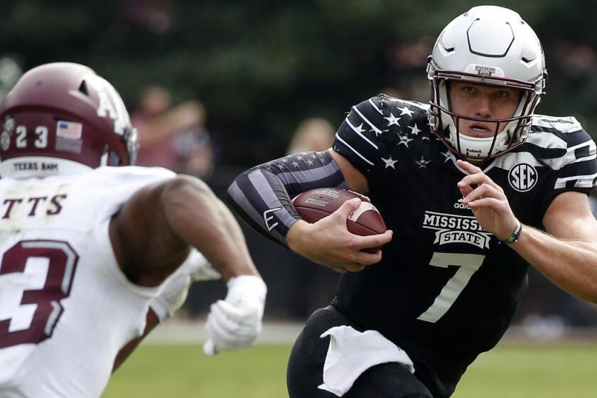 Mississippi State quarterback Nick Fitzgerald runs past Texas A&M defensive back Armani Watts on Nov. 5.