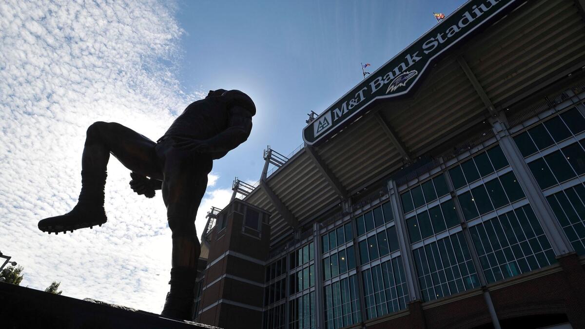 The Ray Lewis statue is silhouetted in front of the M&T Bank Stadium in Baltimore on Sept. 7, 2014.