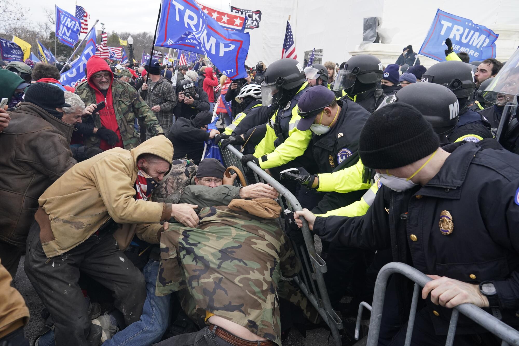 Protesters fight with police.