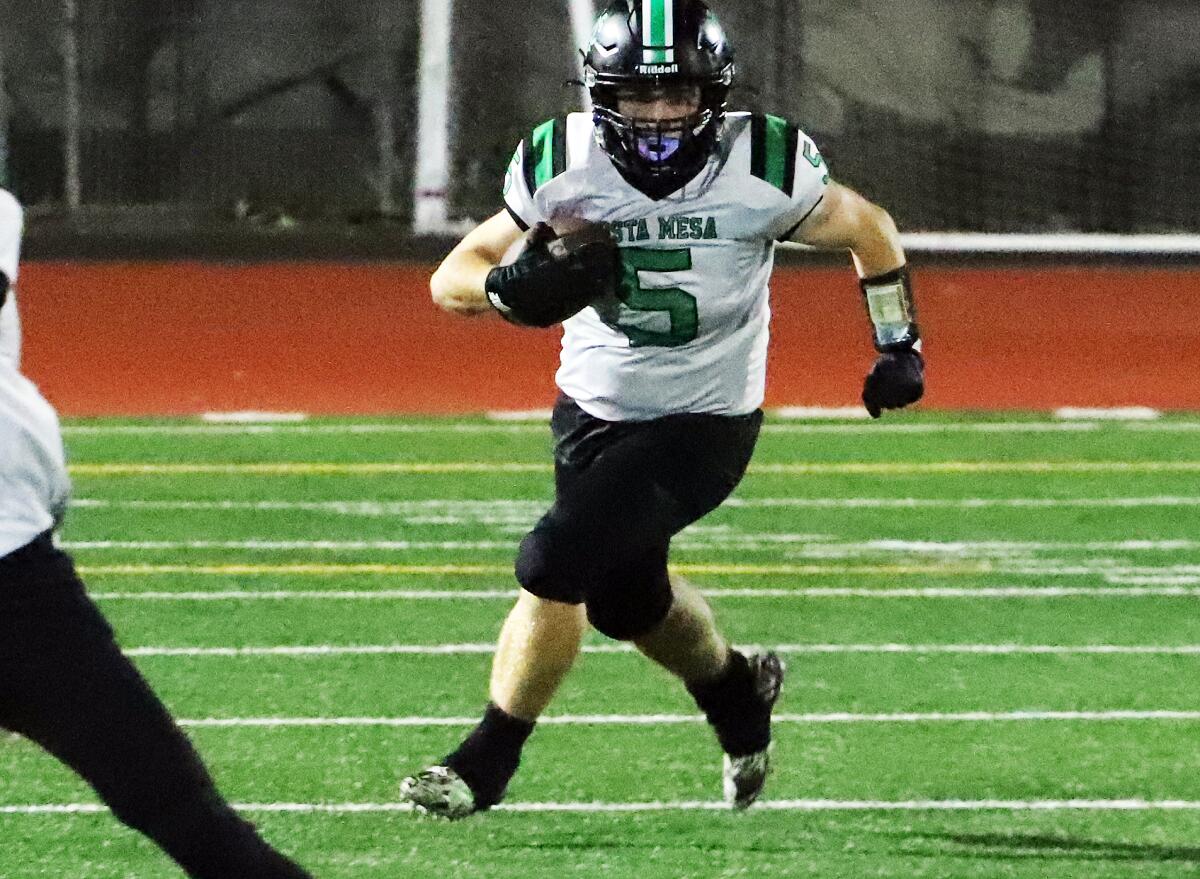 Costa Mesa's Gavin Garza (5) carries the ball against Bolsa Grande in a Tango League game on Thursday.