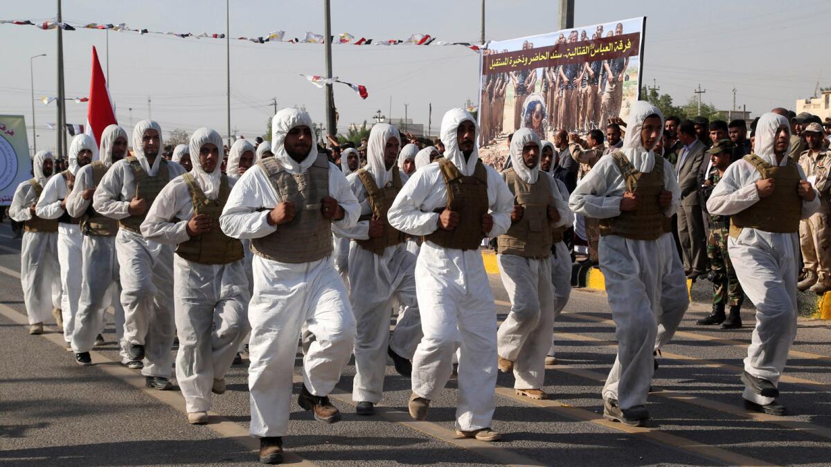 Members of the Abbas combat squad, a Shiite militia group, march during a military parade in Basra, southeast of Baghdad.