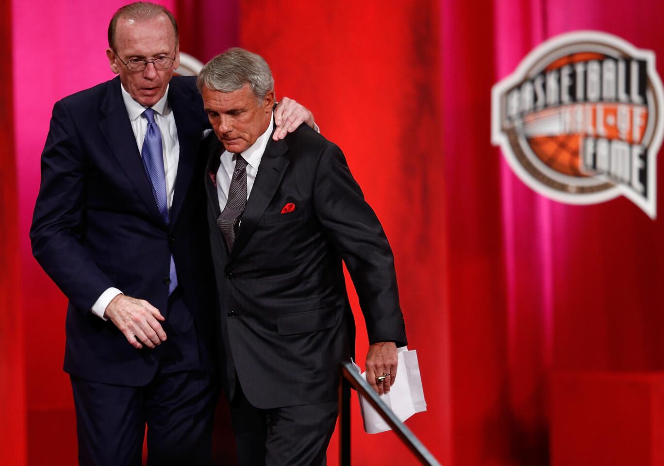 Gary Williams leaves the podium with presenter Billy Cunningham after his enshrinement ceremony at the Naismith Memorial Basketball Hall of Fame.
