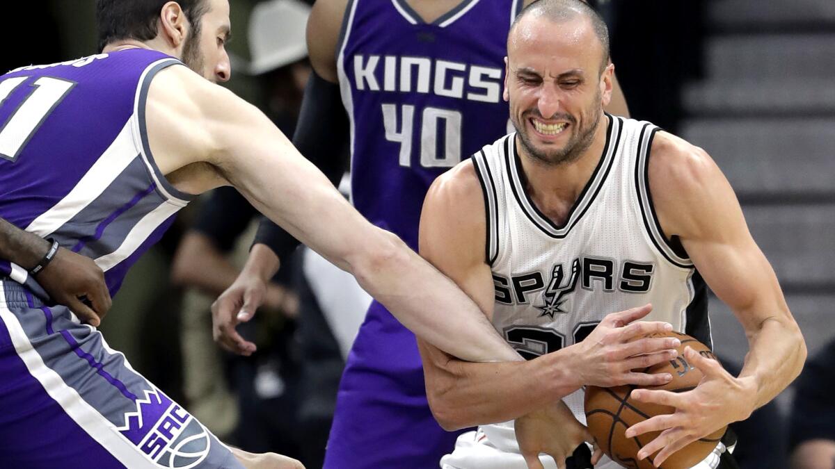Kings center Kosta Koufos (41) tries to strip the ball from Spurs guard Manu Ginobili (20) during the second half Wednesday night.