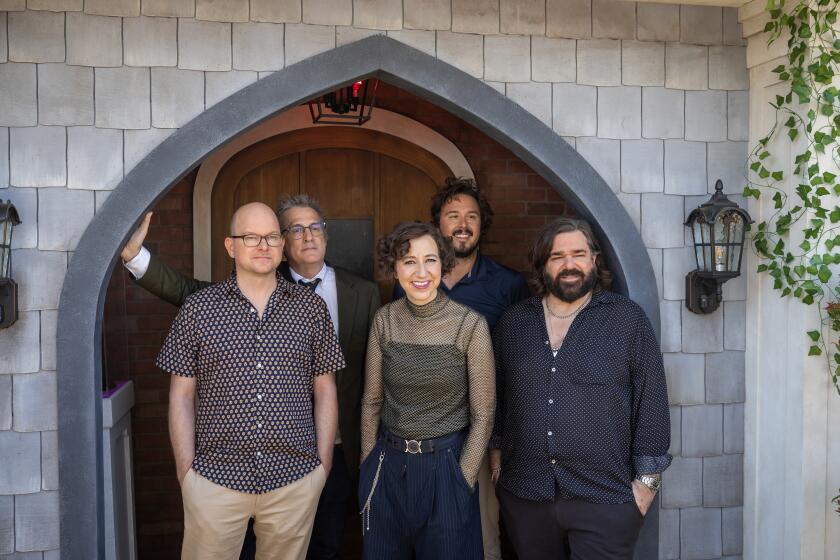 San Diego, CA - July 25: From left: actor Mark Proksch, who plays "Colin Robinson," Paul Simms, Executive Producer, Writer, actor Kristen Schaal, as "the guide", Kyle Newacheck, EP/Director, actor/writer/composer Matt Berry, as "Laszlo" of the FX comedy "What We Do in the Shadows" arrive at the FX Lawn to tour the "Shadows" activation & complete the fan interaction at San Diego Comic-Con Thursday, July 25, 2024 in San Diego. The series is ending with its forthcoming sixth season. (Allen J. Schaben / Los Angeles Times)