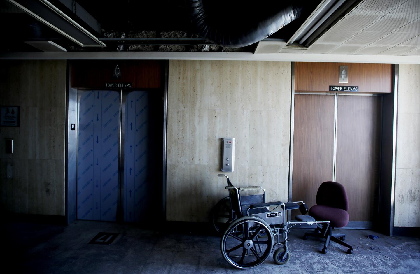 An abandoned wheelchair inside the General Hospital building.