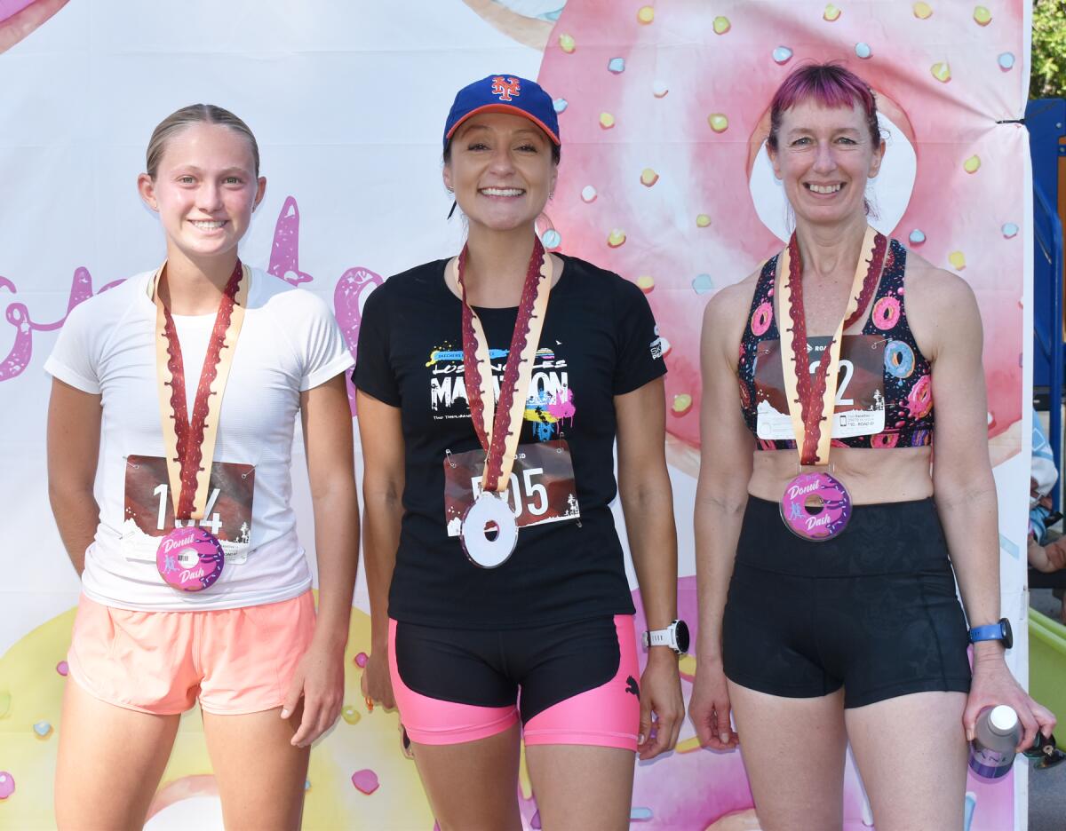 The top three female 5K finishers — Lisa Magill (first), Adriana Gomez (second) and Karen Fawcett (third).