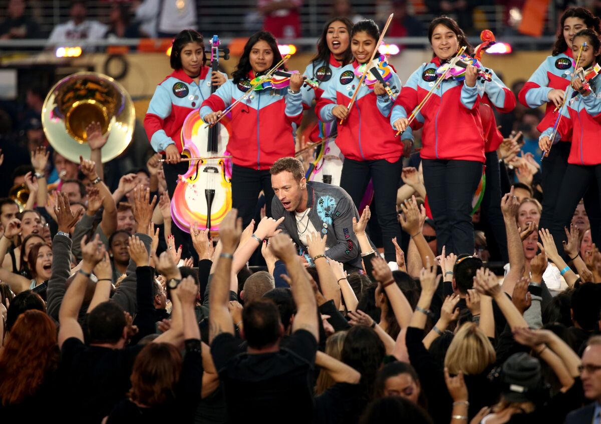 Members of Youth Orchestra Los Angeles back Chris Martin of Coldplay during the Super Bowl halftime show Sunday at Levi's Stadium in Santa Clara.