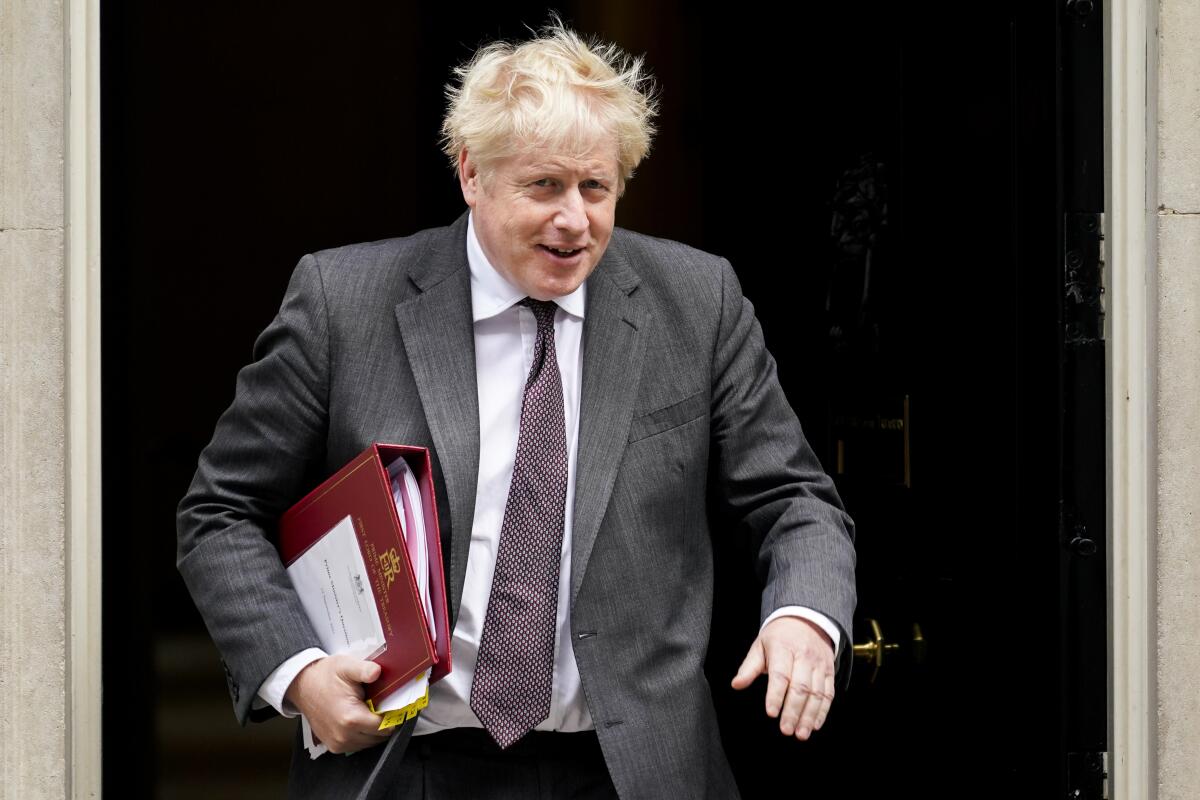 Britain's Prime Minister Boris Johnson leaves 10 Downing Street as he makes his way to Parliament to attend the weekly Prime Minister's Questions session, in London, Wednesday, Sept. 15, 2021. (AP Photo/Alberto Pezzali)