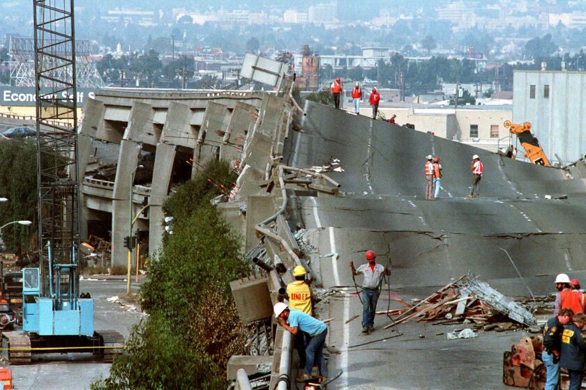 Workers check the damage to Interstate 880 in Oakland after it collapsed during the Loma Prieta earthquake. Centered near Loma Prieta peak in the Santa Cruz Mountains south of San Jose, the quake killed at least 63 people and hospitalized hundreds.