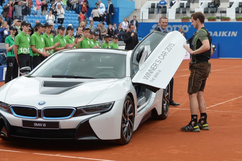 Andy Murray inspects his new car after defeating Philipp Kohlschreiber to win the final match at the BMW Open.