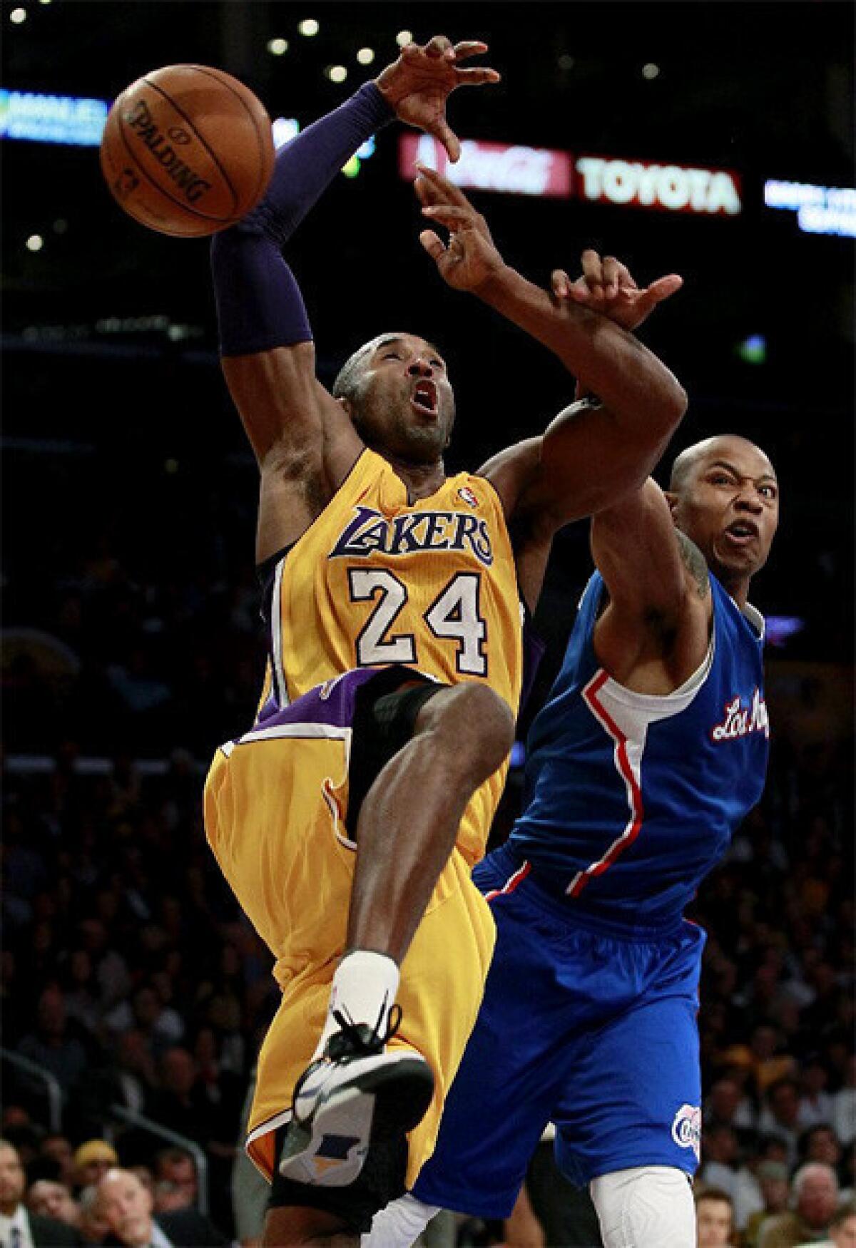 Caron Butler strips the ball from Kobe Bryant as Bryant goes to the basket.