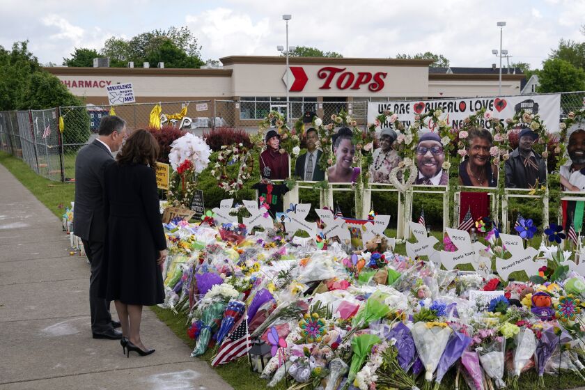 FILE - Vice President Kamala Harris and her husband Doug Emhoff visit a memorial near the site of the Buffalo supermarket shooting after attending a memorial service for Ruth Whitfield, one of the victims of the shooting, Saturday, May 28, 2022, in Buffalo, N.Y. The victims of the mass shooting will be honored with a permanent memorial in the neighborhood. Gov. Kathy Hochul and Mayor Byron Brown on Friday, Oct. 21, 2022, announced the creation of a commission tasked with planning and overseeing construction of a monument in East Buffalo.(AP Photo/Patrick Semansky, File)