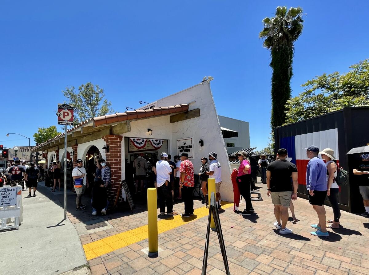 Diners wait in line outside Heritage Barbecue in San Juan Capistrano.