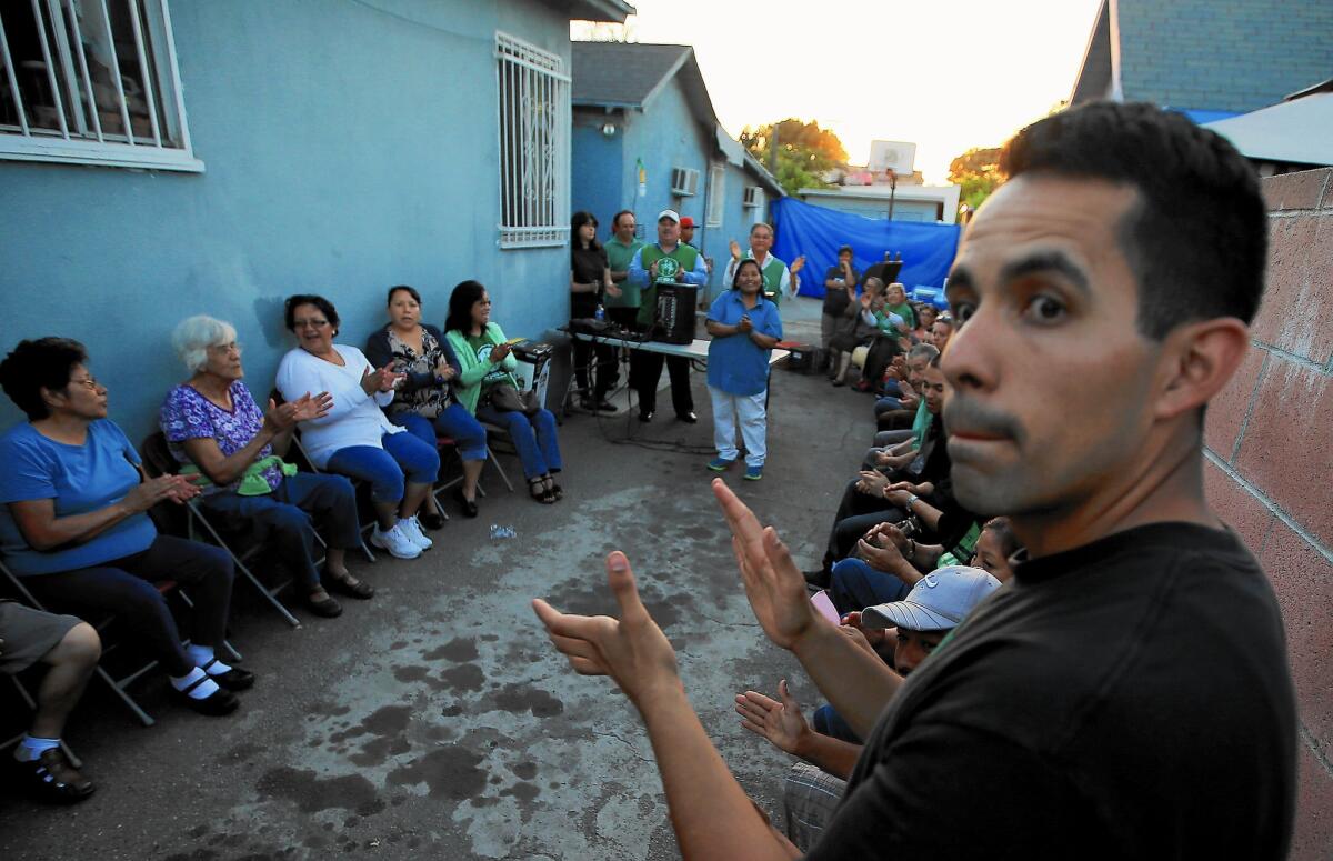 Community members gather at an Eastside home to celebrate the Exide agreement. Residents want the company to follow through on the cleanup of lead in their neighborhoods and homes.