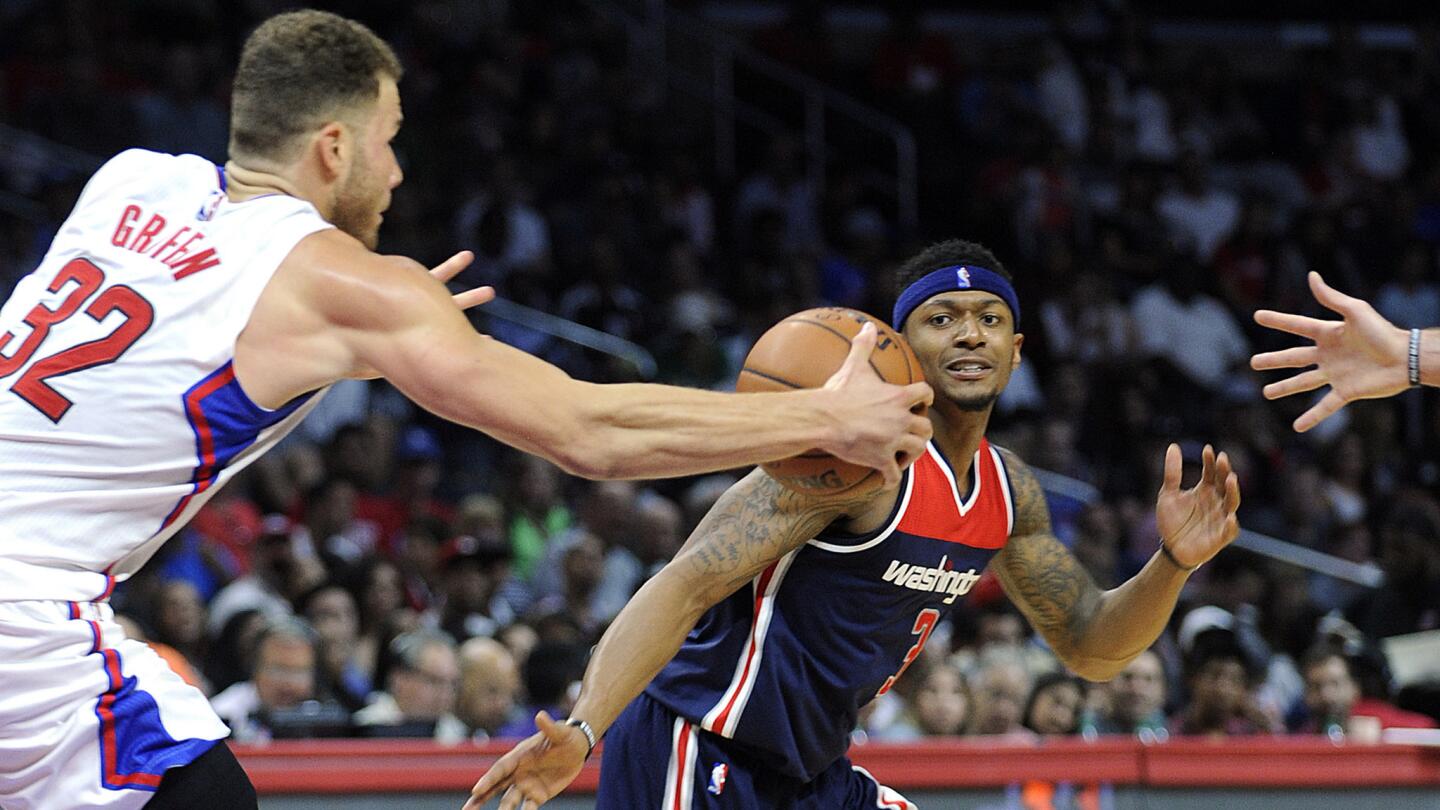 Clippers forward Blake Griffin, left, collects a loose ball in front of Wizards guard Bradley Beal.