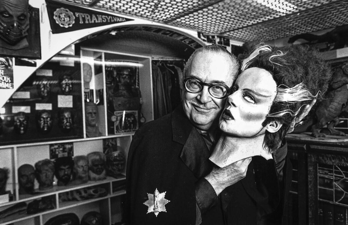 April 1982: Science fiction collector Forrest J. Ackerman shows off a Frankenstein's Bride mask.