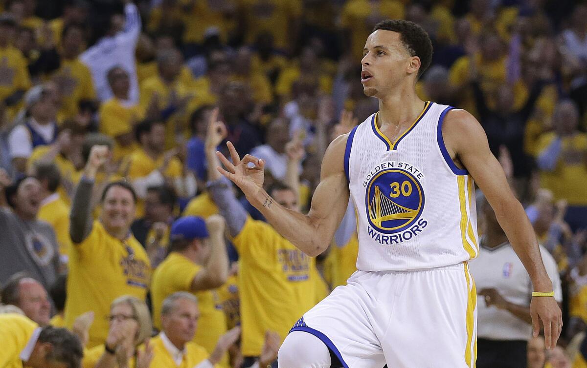 Golden State Warriors' Stephen Curry celebrates after a score during the first quarter of Game 1 of the NBA basketball Western Conference finals against the Houston Rockets.