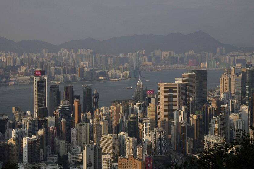 Victoria Harbour is seen in Hong Kong on Nov. 30, 2021. The bustling, cosmopolitan business hub of Hong Kong may be losing its shine among foreign companies and expatriates with its stringent anti-pandemic rules requiring up to 21 days of quarantine for new arrivals. (AP Photo/Kin Cheung)