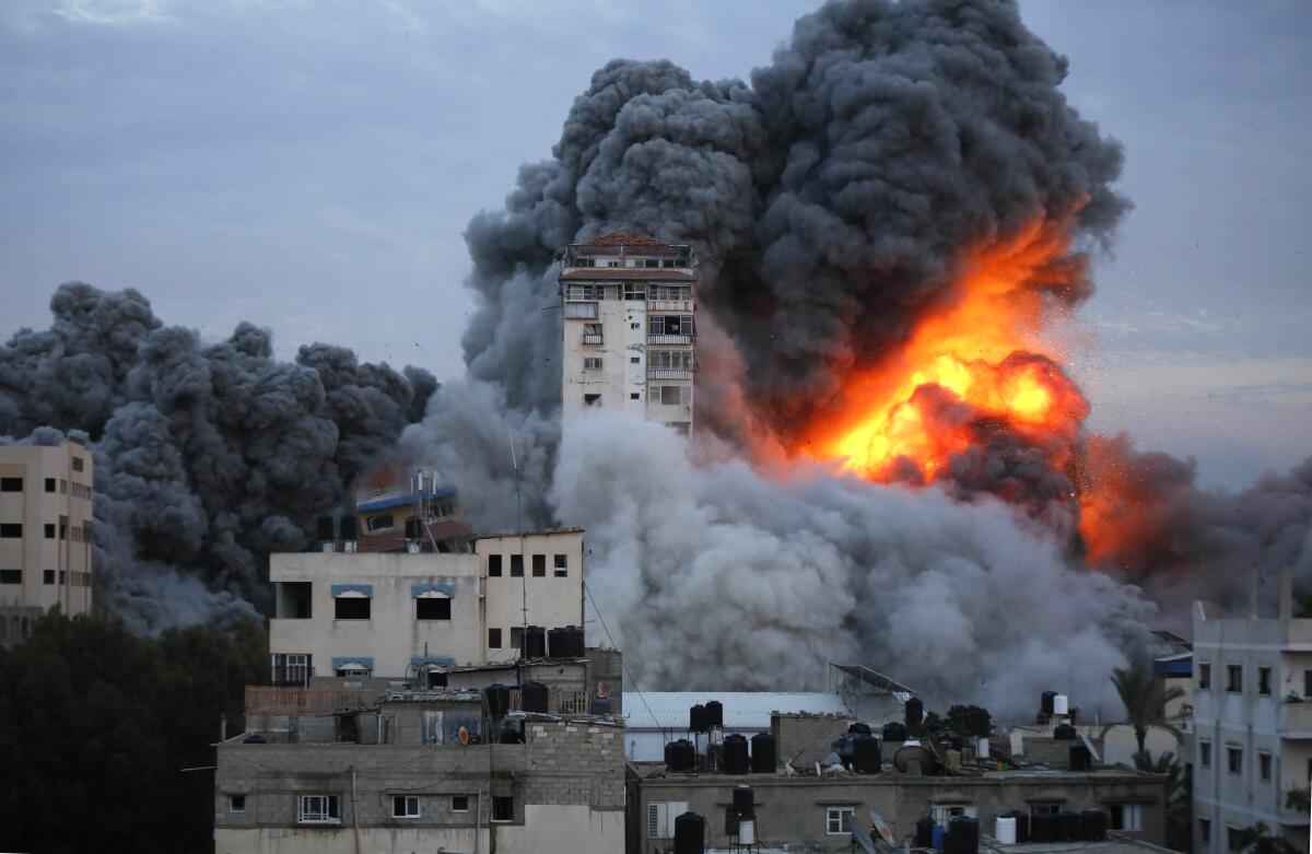 Smoke and flames erupt from an airstrike on a building.