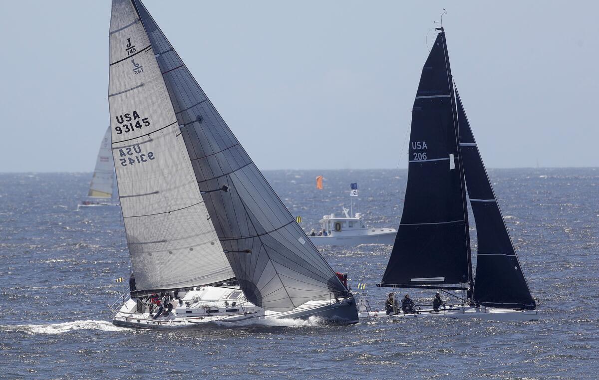 Boats jockey for position in gusty winds at the start off.