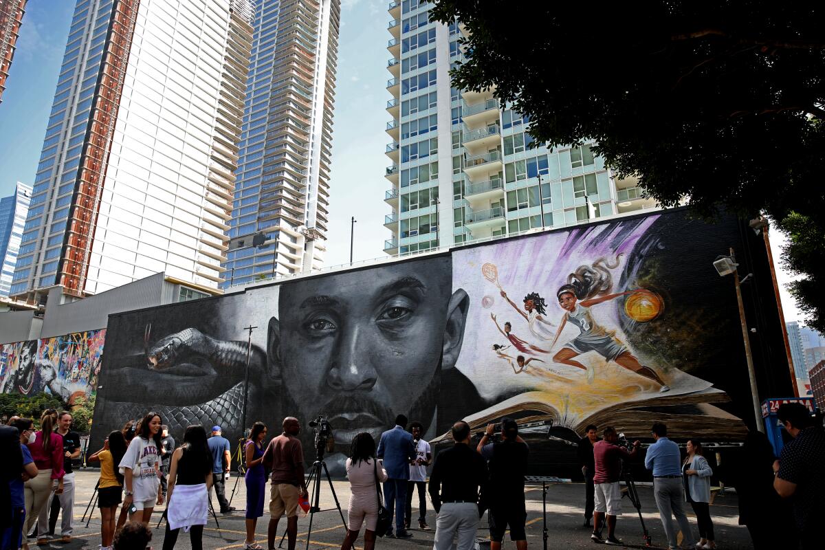 A crowd gathers for unveiling of a mural honoring Kobe Bryant