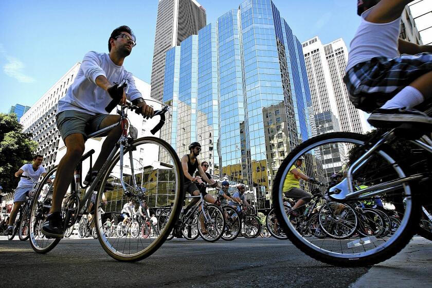 Cyclists ride through downtown Los Angeles during CicLAvia, which closes streets to car traffic, in October. The events understandably upset some drivers but can be eye- and mind-opening.