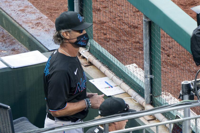 Miami Marlins' manager Don Mattingly looks out from the dugout during the eighth inning of a baseball game against the Philadelphia Phillies, Saturday, July 25, 2020, in Philadelphia. (AP Photo/Chris Szagola)