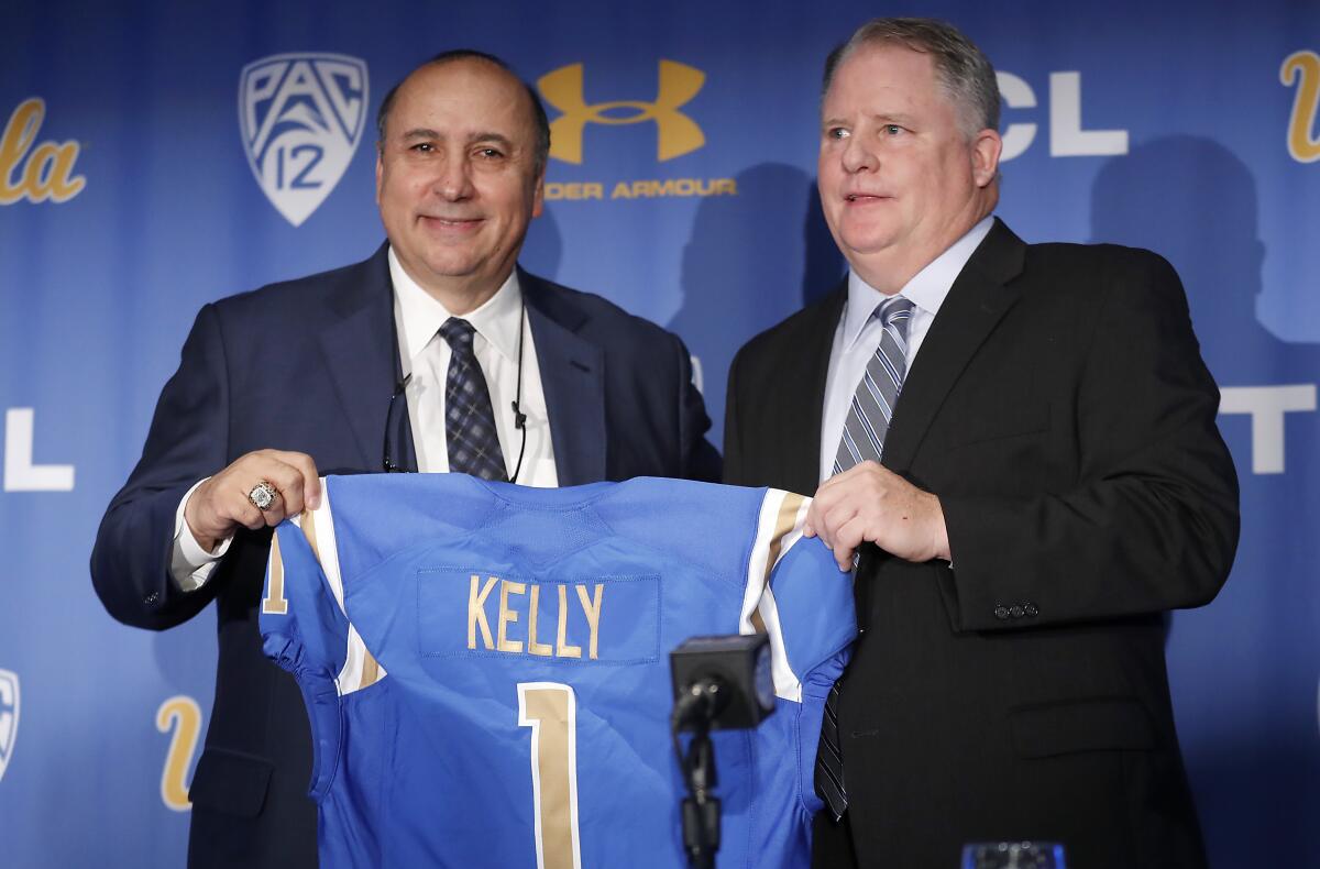 UCLA athletic director Dan Guerrero, left, hired football coach Chip Kelly on a five-year, $23.9-million contract in 2017.