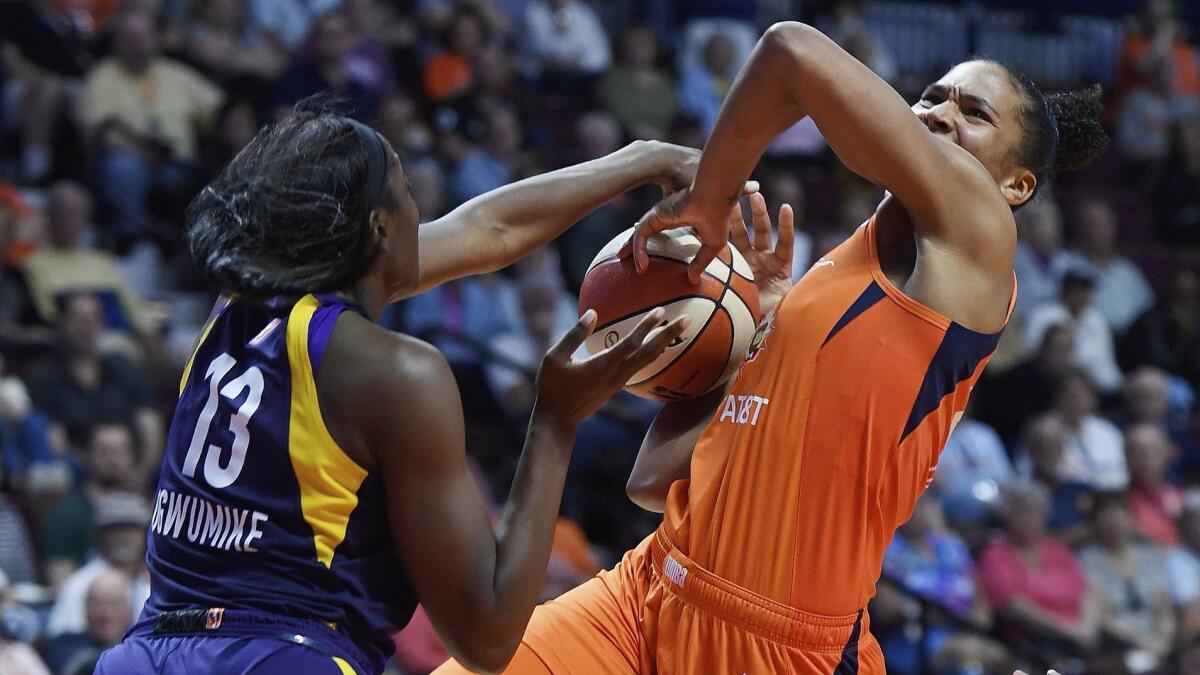 Sparks center Chiney Ogwumike (13) blocks a shot by Sun forward Alyssa Thomas during the second half Thursday.