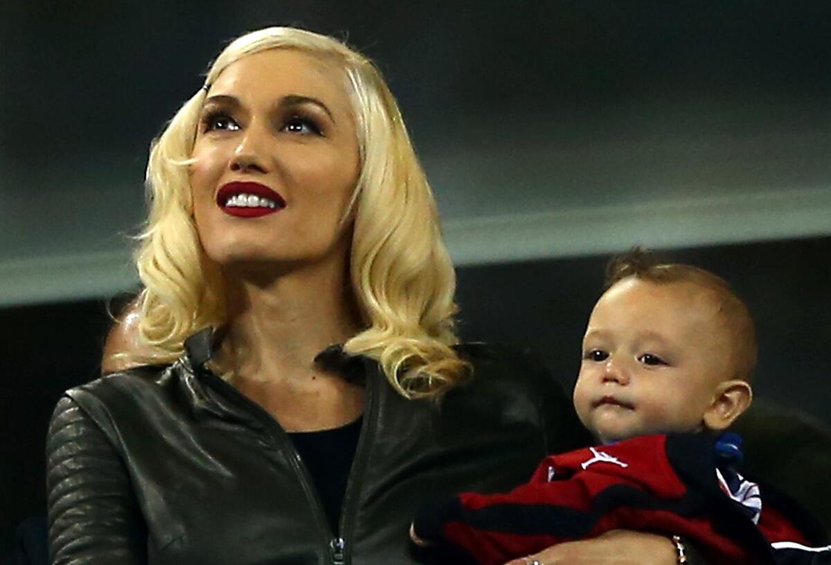 Gwen Stefani holds her son Apollo Bowie Flynn Rossdale on Thursday at the U.S. Open in New York.