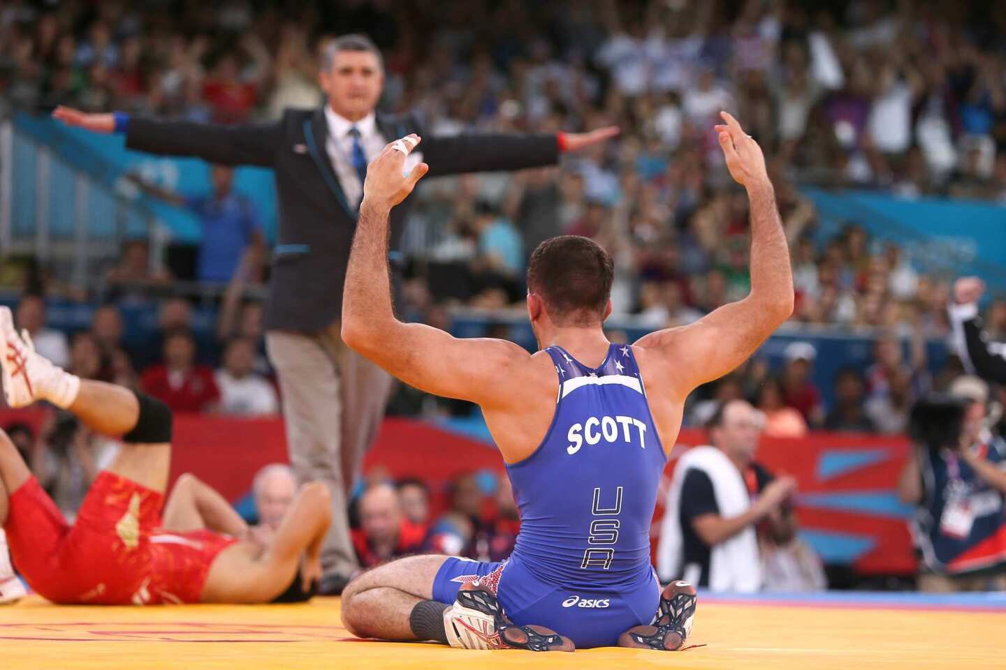 Coleman Scott celebrates after defeating Japan's Kenichi Yumoto in their men's 60kg freestyle bronze medal match.