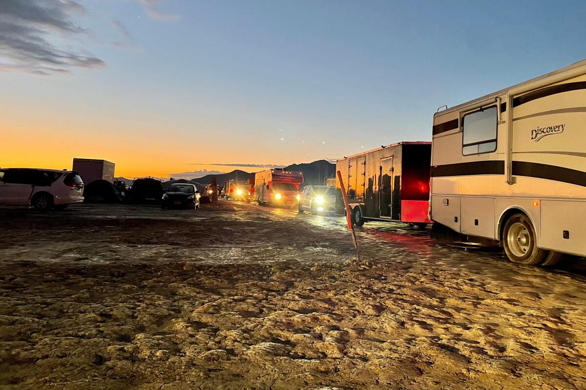 Vehicles line up to leave the site of the annual Burning Man Festival, after heavy rains turned the site into a mud pit.