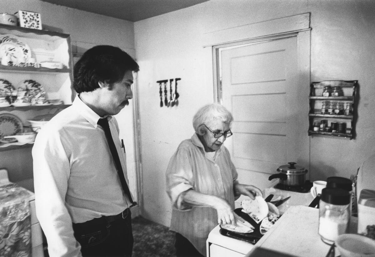 Times reporter George Ramos with grandmother Felicitas Ramos in the house where he grew up.