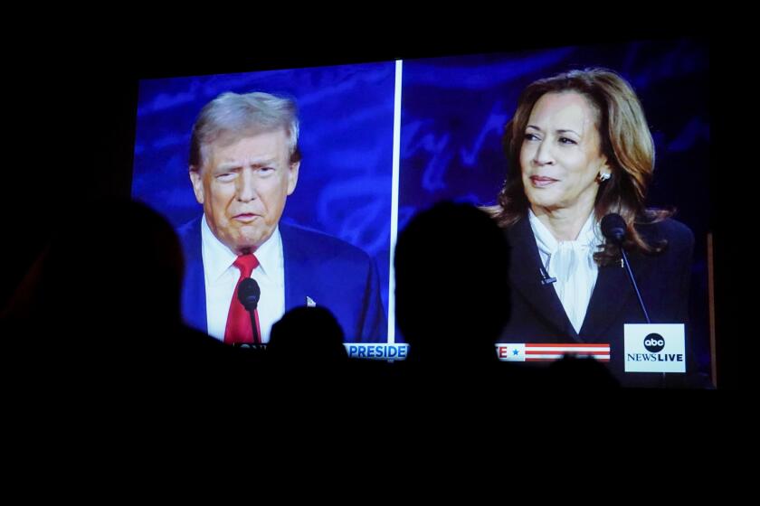 Former US President Donald Trump and US Vice President Kamala Harris are shown on screen during a debate watch party at the Cameo Art House Theatre in Fayetteville, North Carolina, US, on Tuesday, Sept. 10, 2024. Donald Trump and Kamala Harris enter Tuesday's debate in search of the same goal, a moment that will help them gain the edge in a race polls show is essentially tied. Photographer: Allison Joyce/Bloomberg via Getty Images