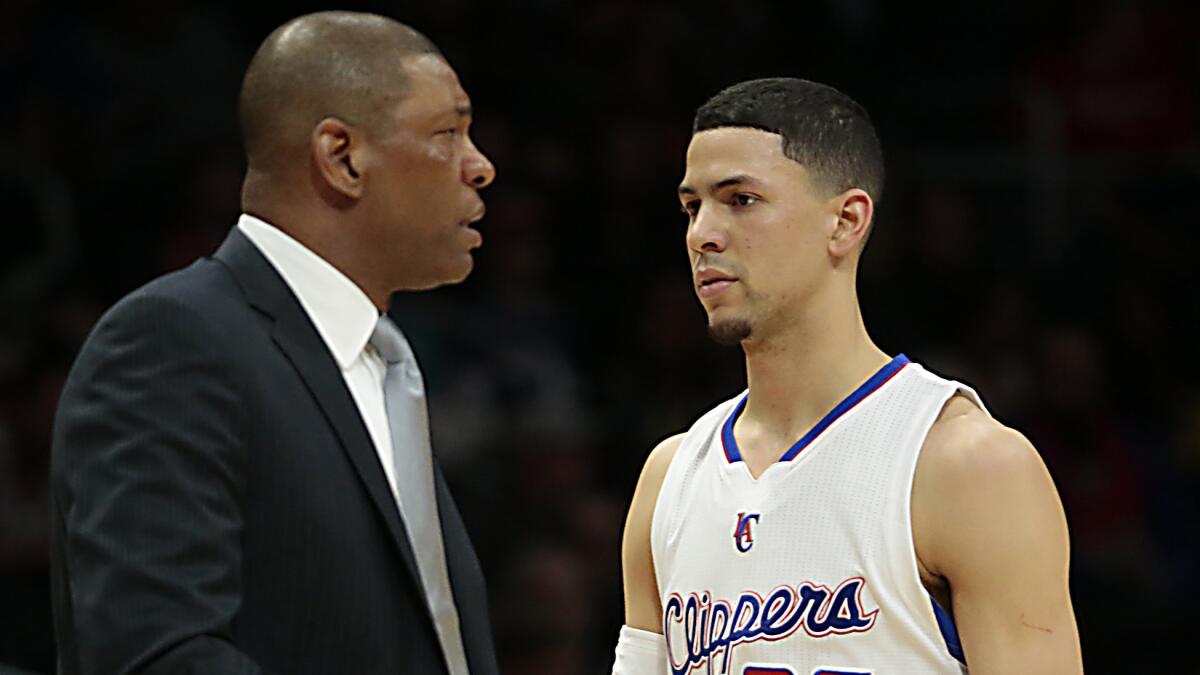 Clippers guard Austin Rivers with his father, Clippers Coach Doc Rivers, during a game against the Denver Nuggets on Jan. 29.